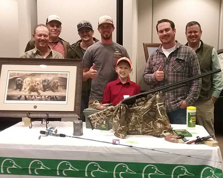 Pack Forster (center)  wins gun, print with help from his new friends