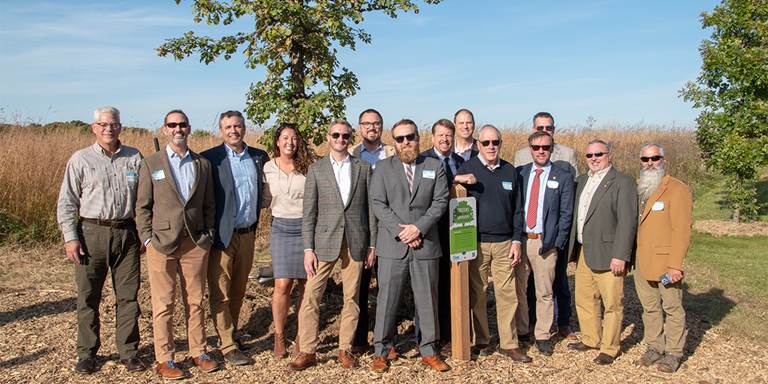Partners celebrate the first of 6 million trees near Milwaukee to improve sewage system capacities.