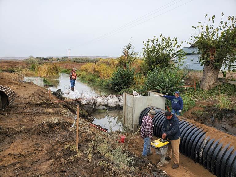 Workers install a diversion structure for water management on the Satus Wildlife Area. 